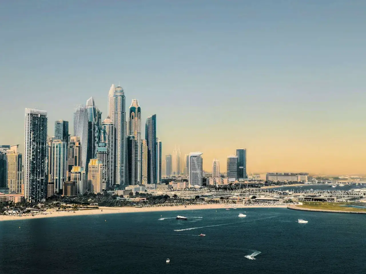 Widok na drapacze chmur w Dubaju, plażę i morze. Zastanawiasz się, co zabrać do Dubaju? Lekkie ubrania i strój kąpielowy będą idealne!